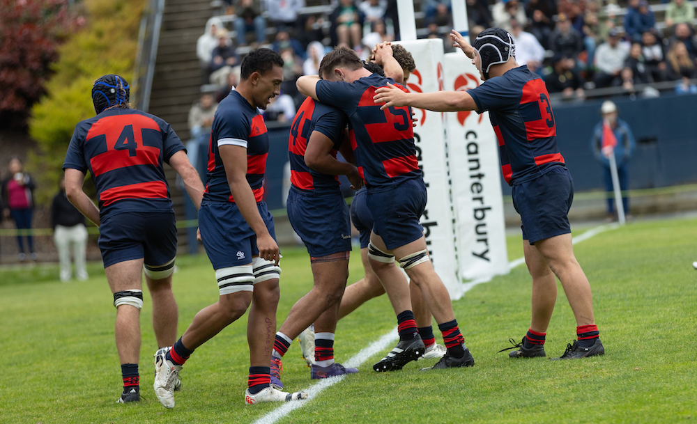 Men's rugby players celebrate a try against Cal, 2024