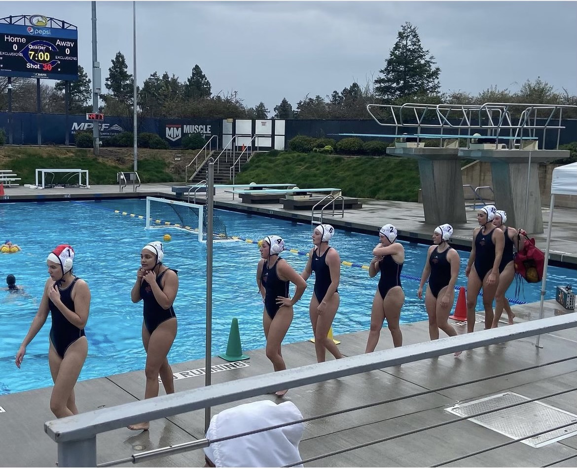 Women's Water polo team line up to shake hands with opposing team