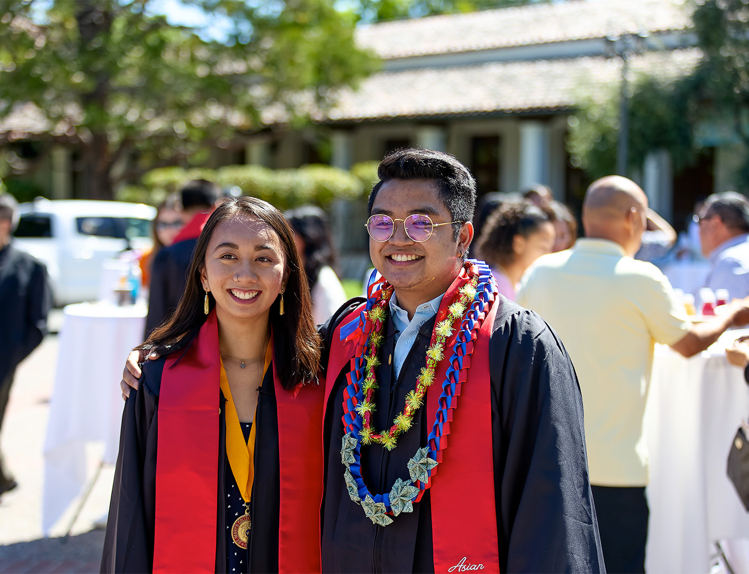 Two graduates posing for a photo after graduation