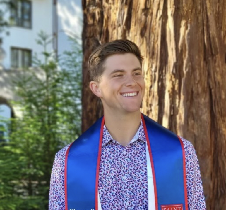 A finance degree student posing with a graduation stole around his neck
