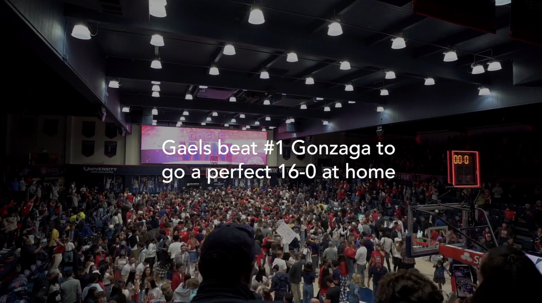 The text Gaels Beat #1 Gonzaga to go a perfect 16-0 at home over a crowd cheering
