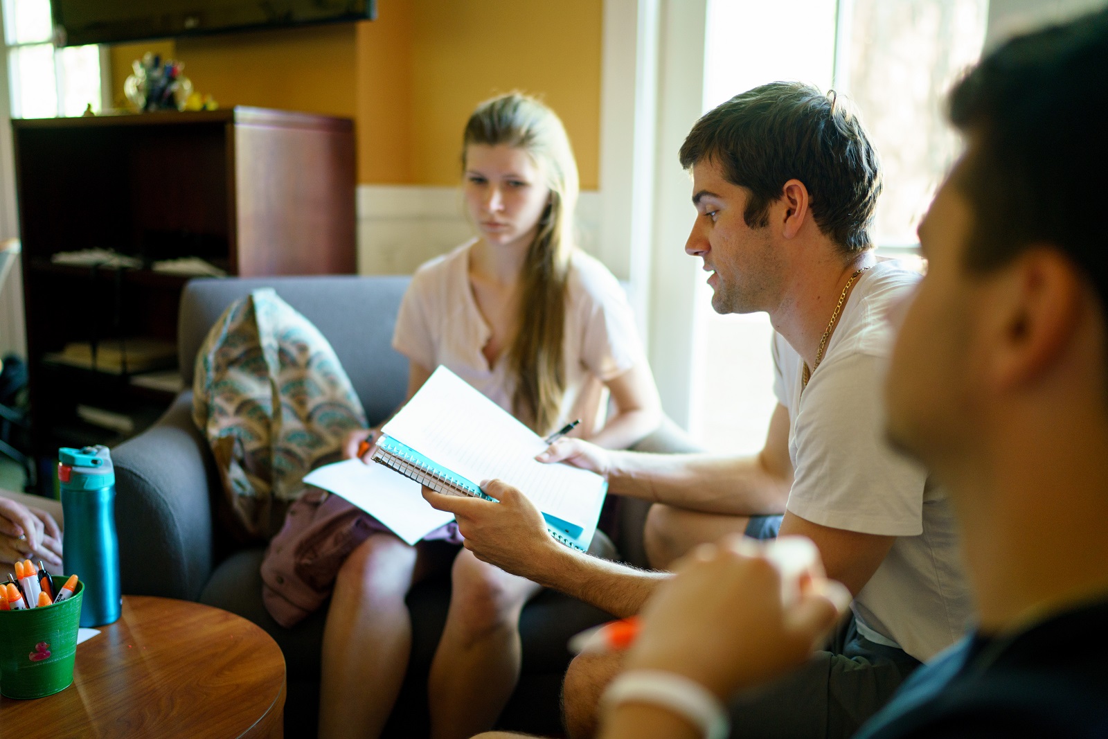 Students in a Writing Circle looking at a paper in the Writing Center