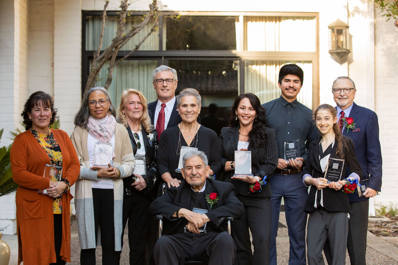 2023 Alumni Awards recipients, smiling and holding awards