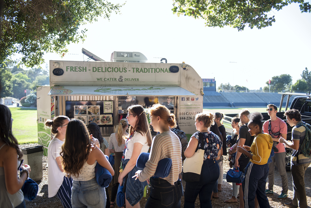 Students gathered outside of a food truck