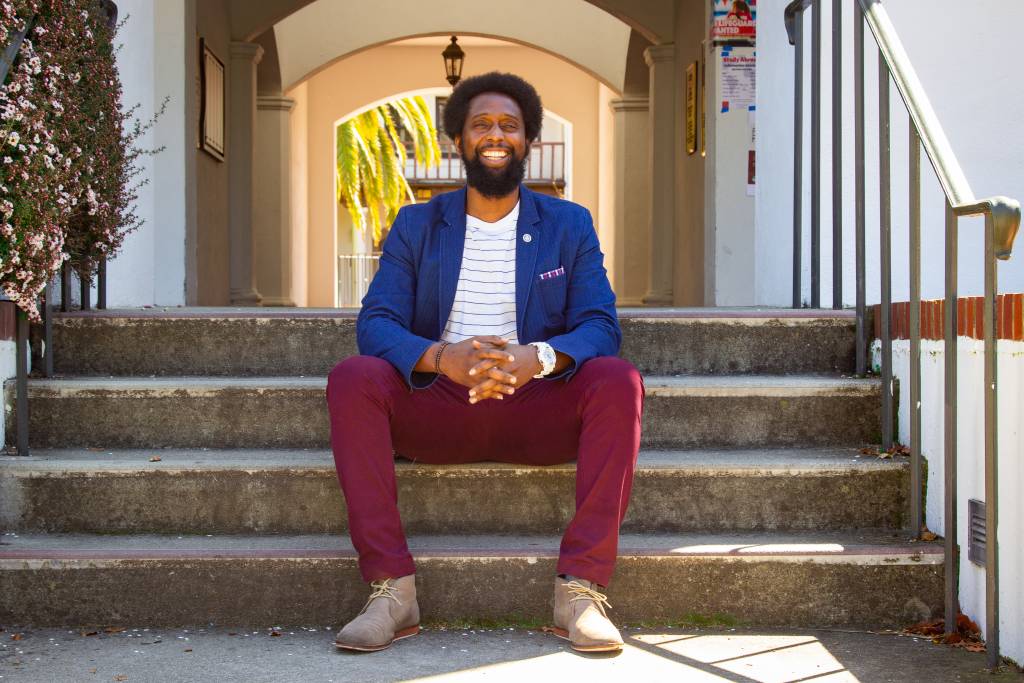 A counseling student on the stairs by the chapel breezeway