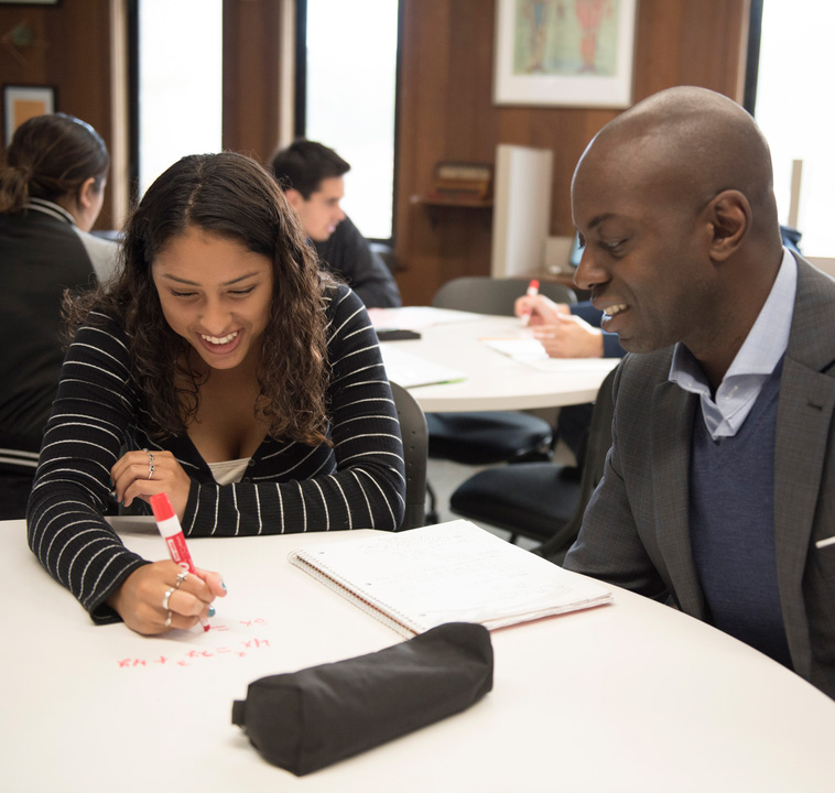 student and teacher at desk