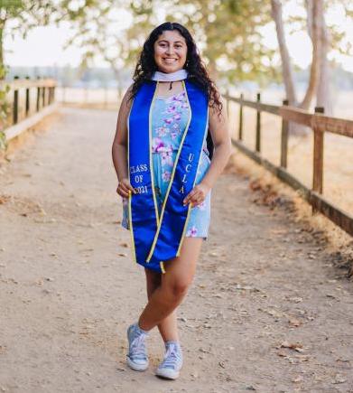 young woman standing in dirt path