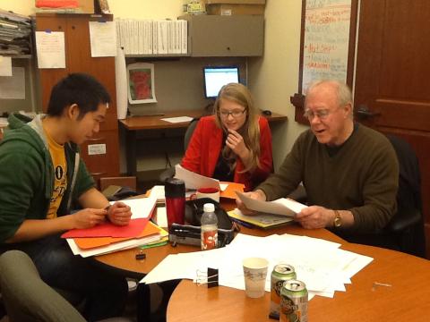 2012 MFA Graduates Andrew Taw and Casey McAlduff review entries with Robert Hass