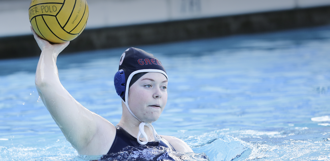 A women's water polo player throwing the ball