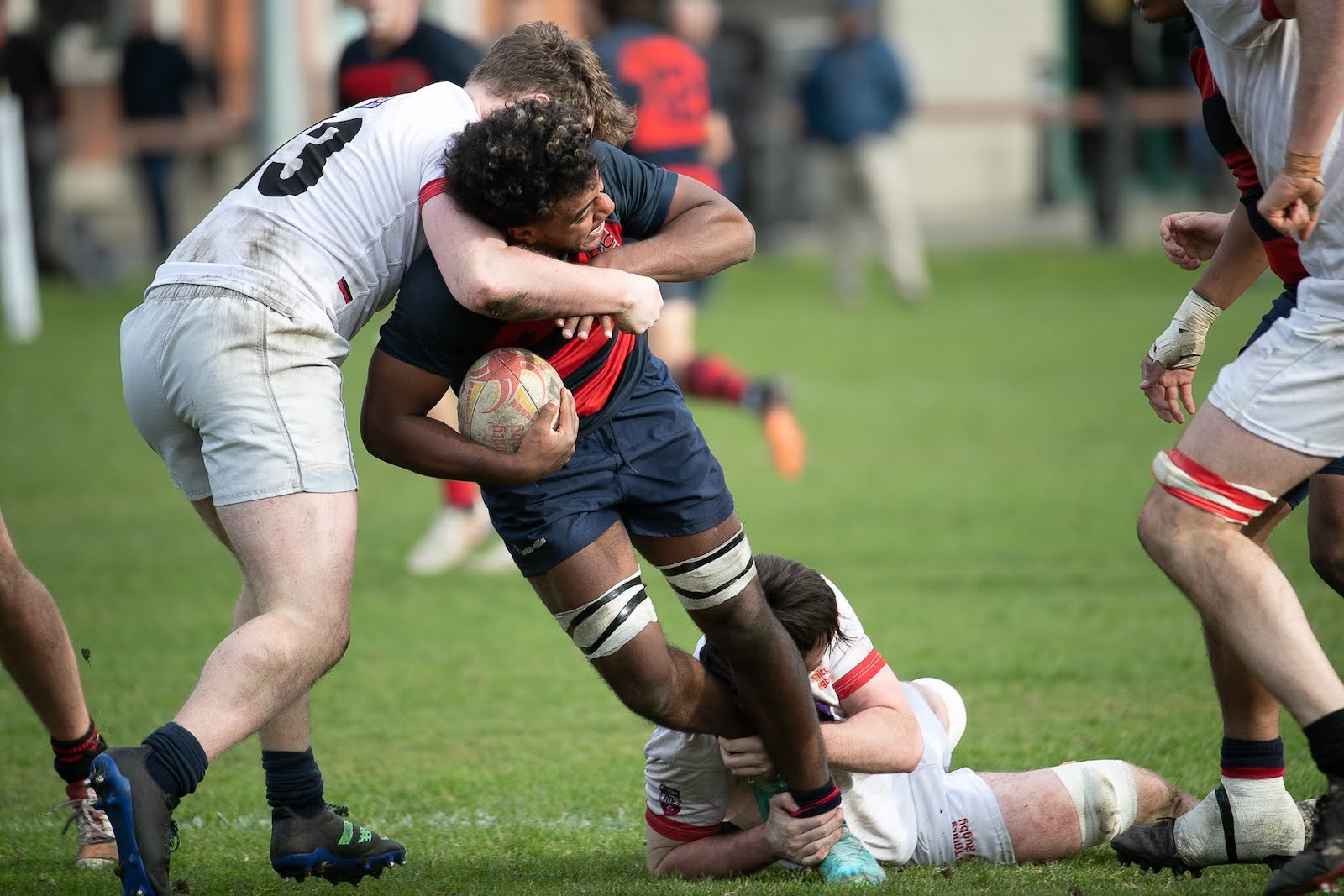 SMC Rugby player pushing through Trinity defense