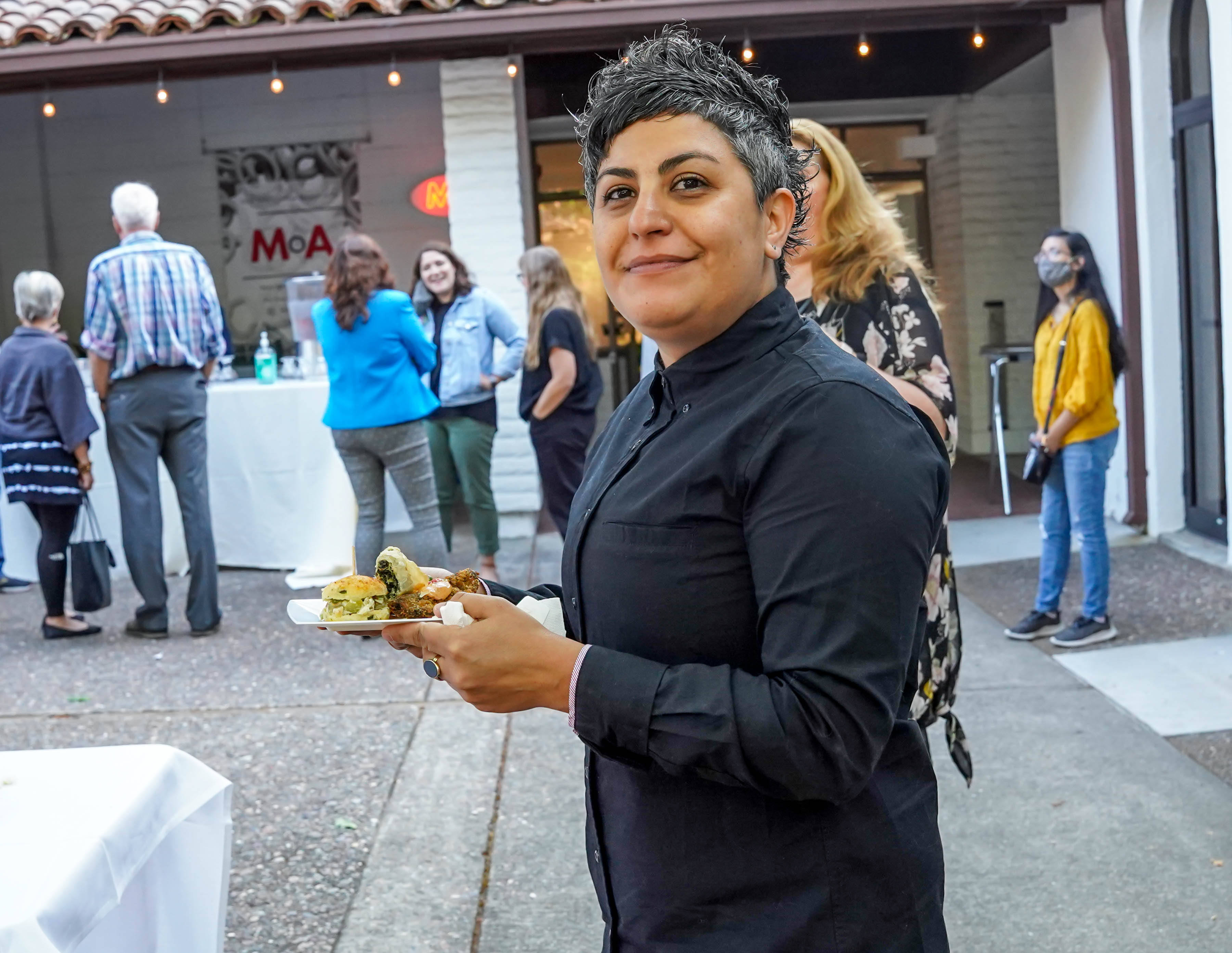person holding plate and museum opening