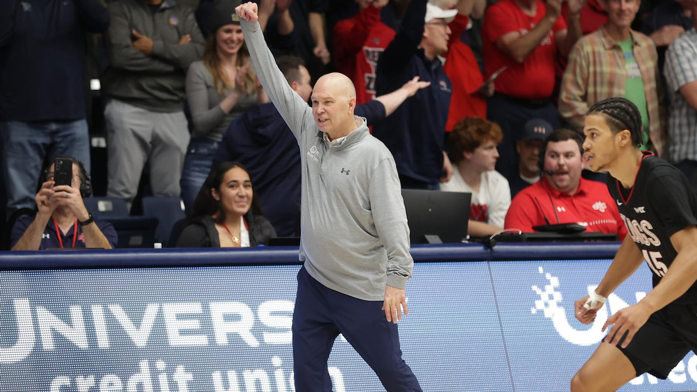 Coach Randy Bennett with hand raised in victory