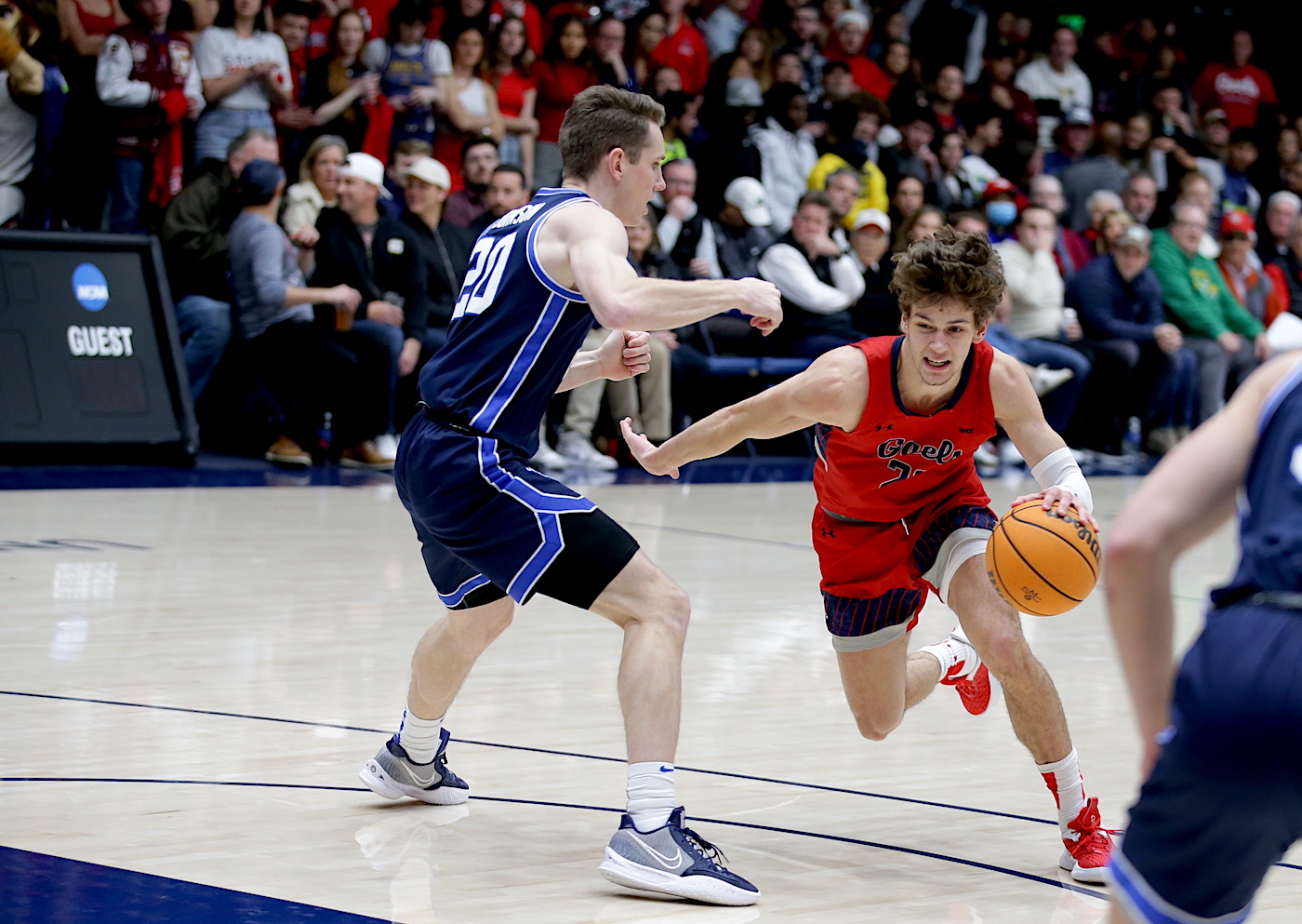 Basketball player Aiden Mahaney drives against BYU