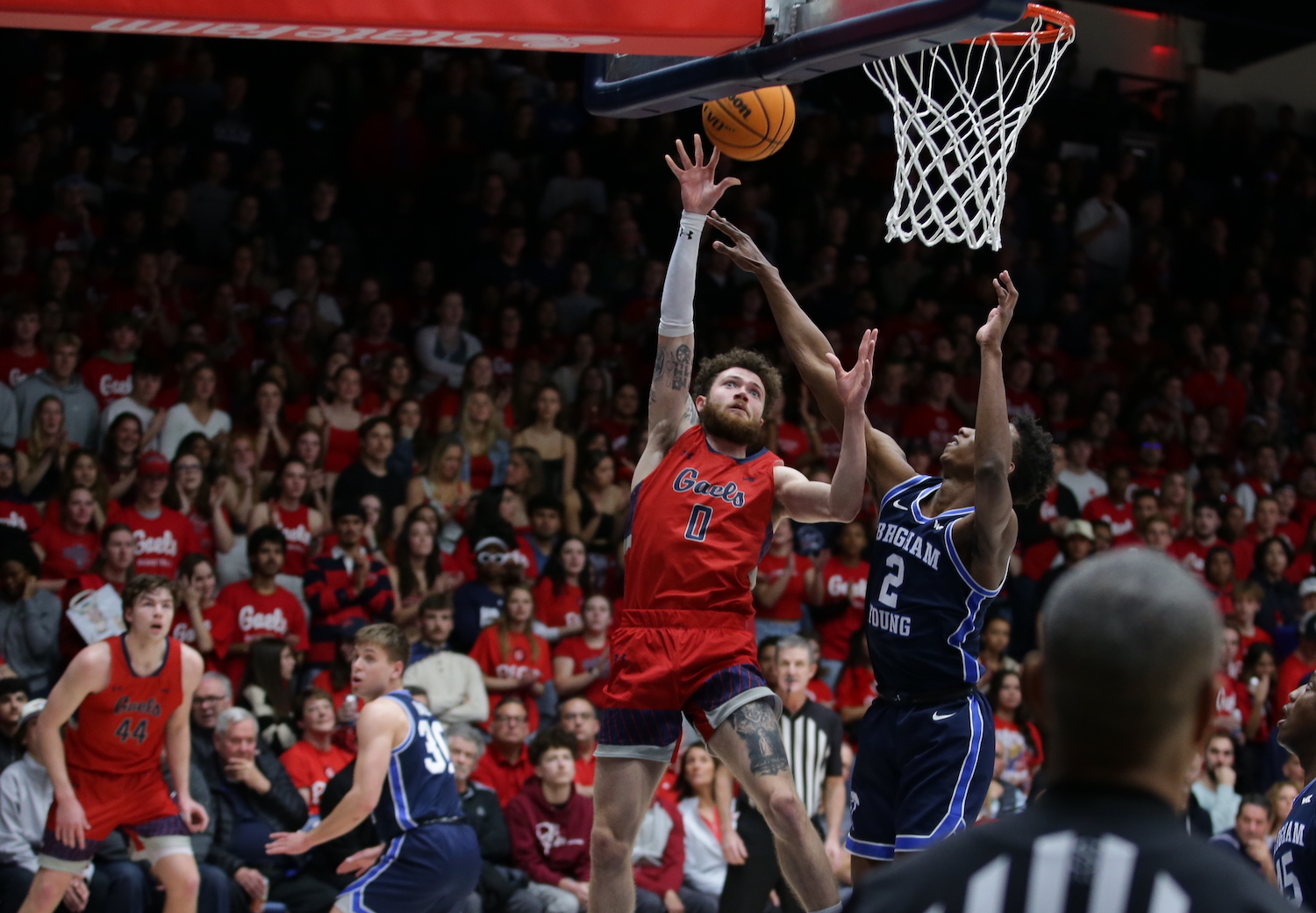 Basketball player Logan Johnson shoots against BYU on February 18