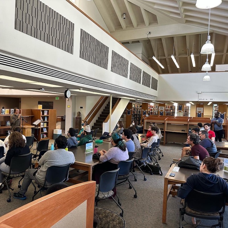a photo of a poetry reading in the library