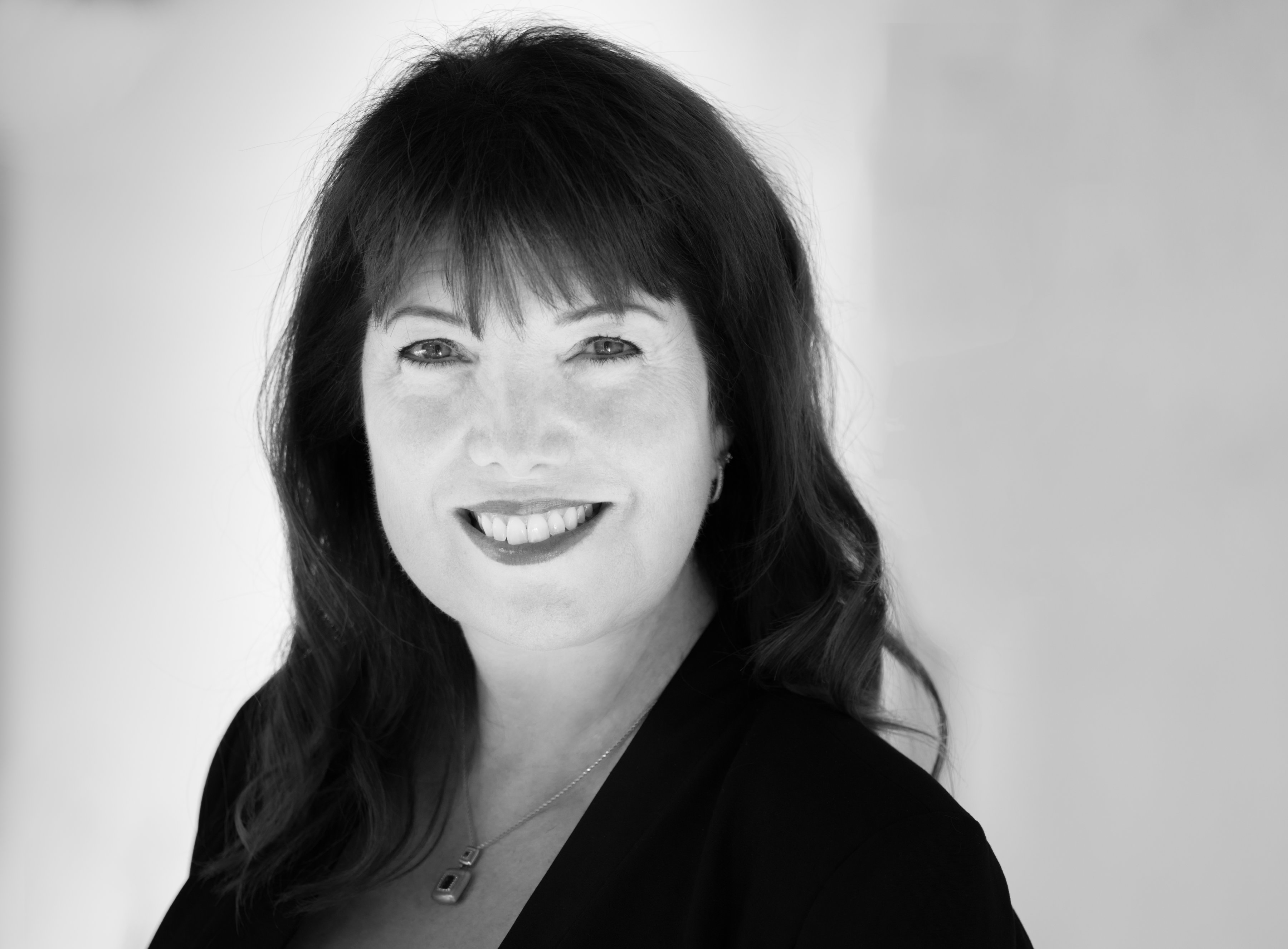 A black-and-white headshot of Dr. Julie Ford