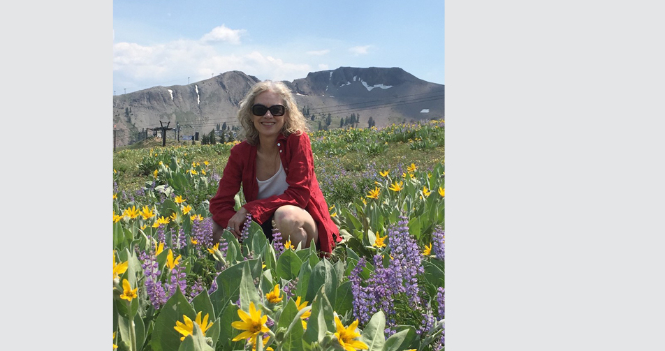 Brenda Hillman in a field of flowers on Tahoe Peak