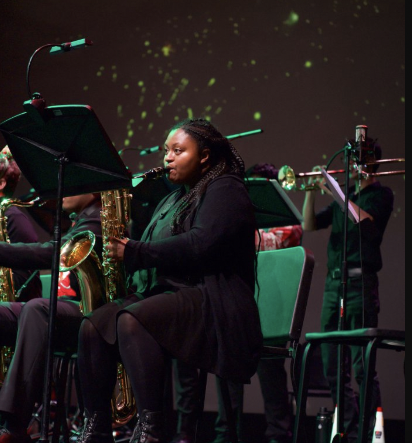 A saxophone player reading off her music stand