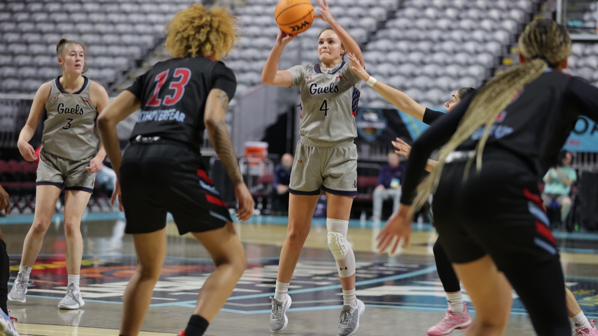 Taycee Wedin shoots a 3-pointer while teammate Leia Hanafin looks on.