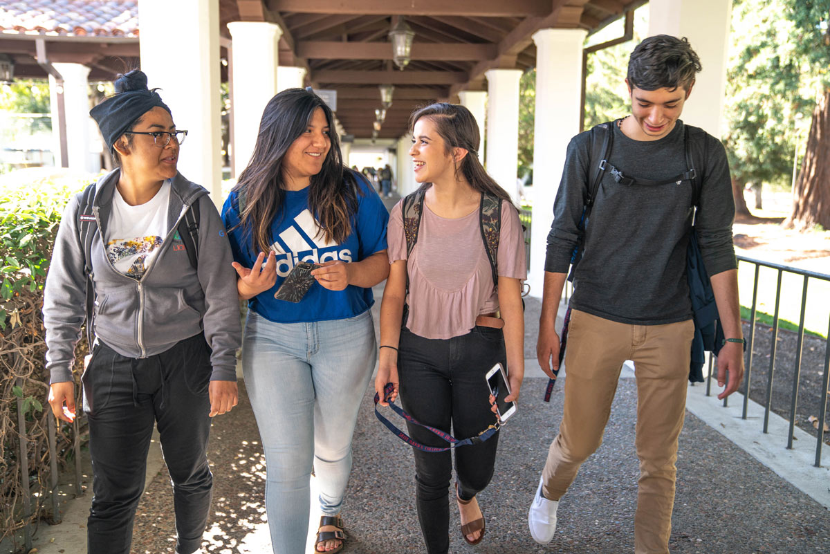 students walking together and talking on campus