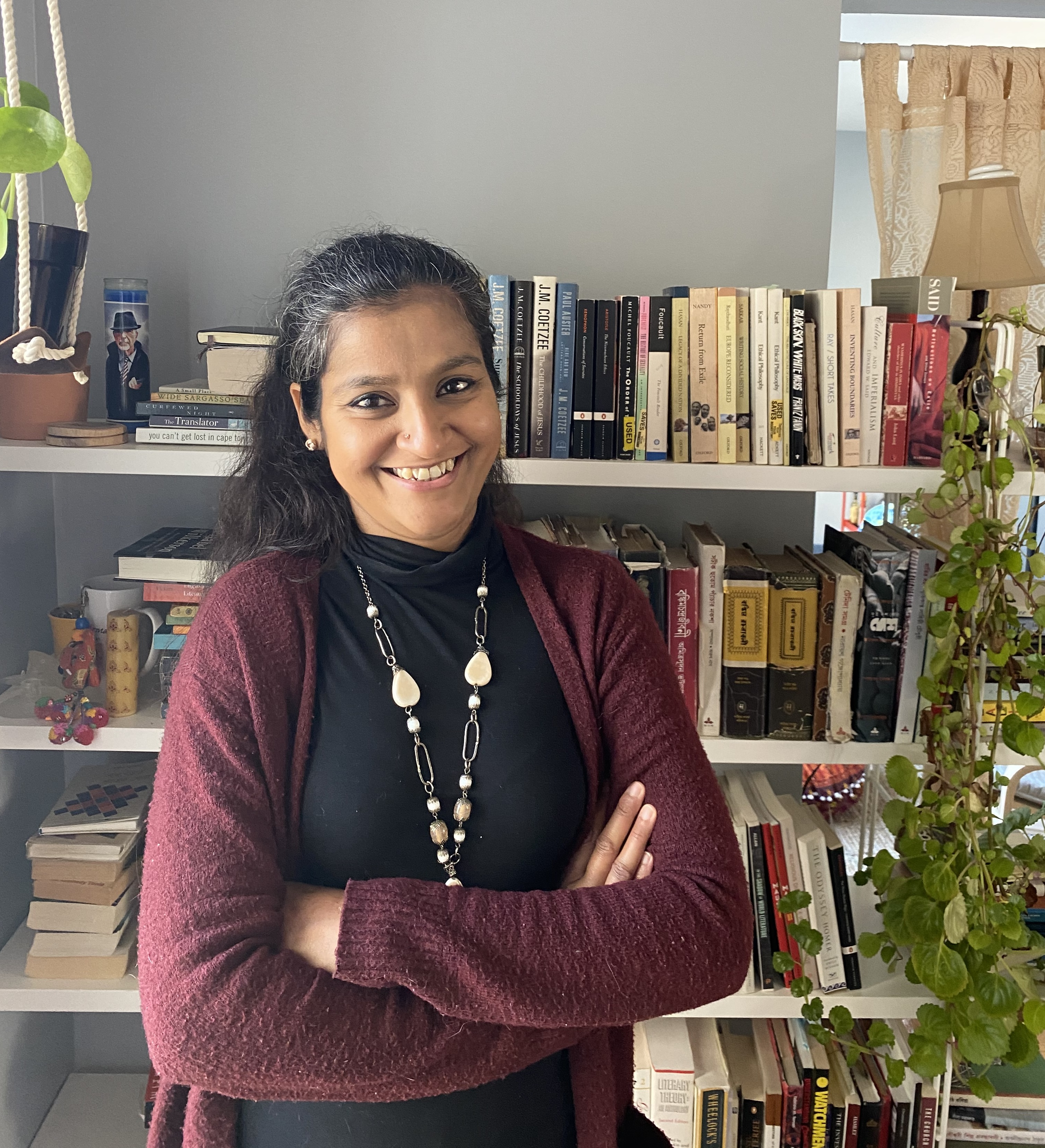 Photo of Prof. Sunayani Bhattacharya standing in front of bookcase
