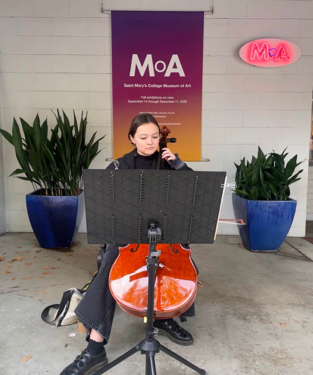 student playing the cello at the museum