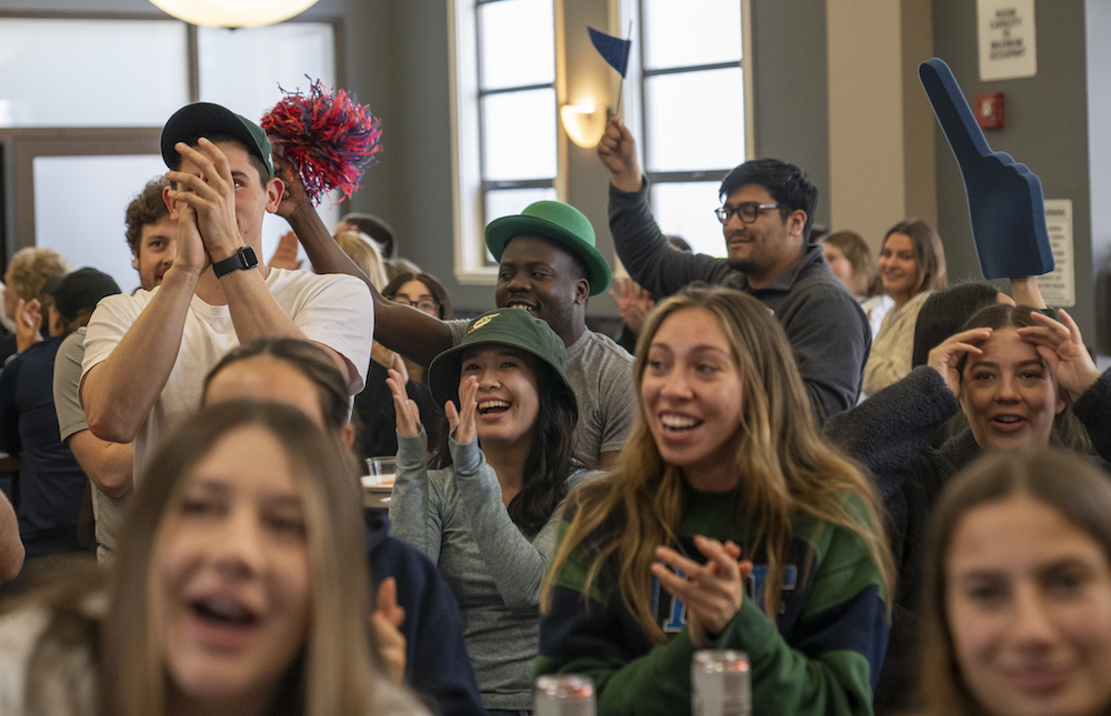 Students cheer at the 1928 Pub as they watch men's basketball beat VCU on March 17 2023