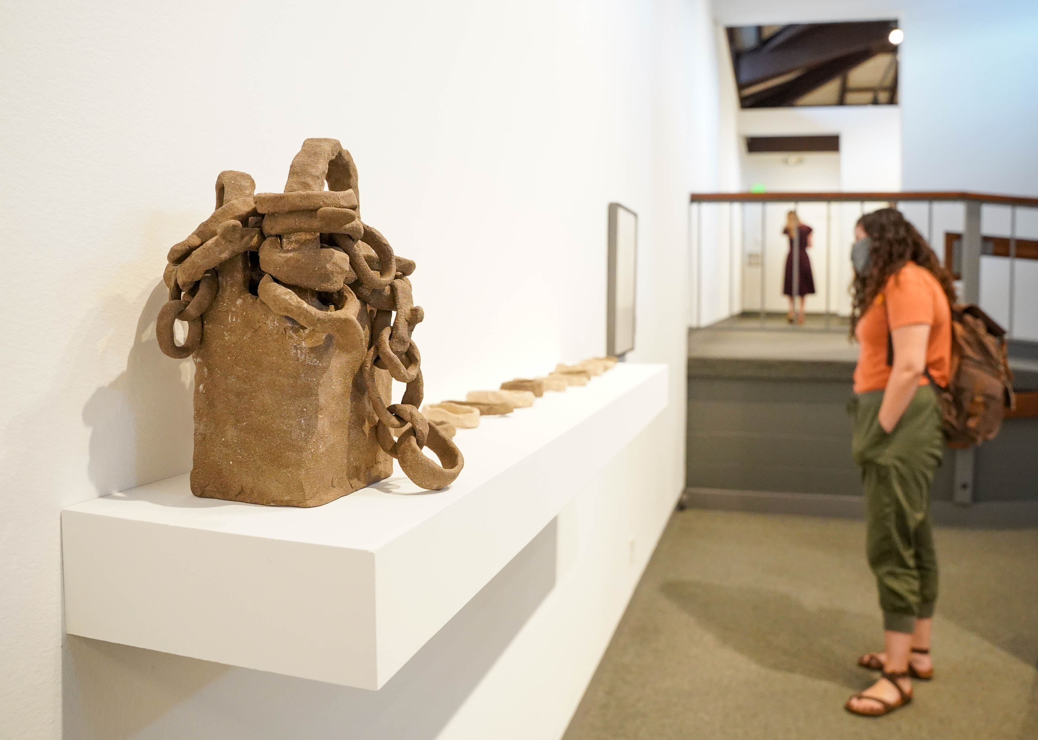 A visitor appreciating a sculpture at the Museum of Art