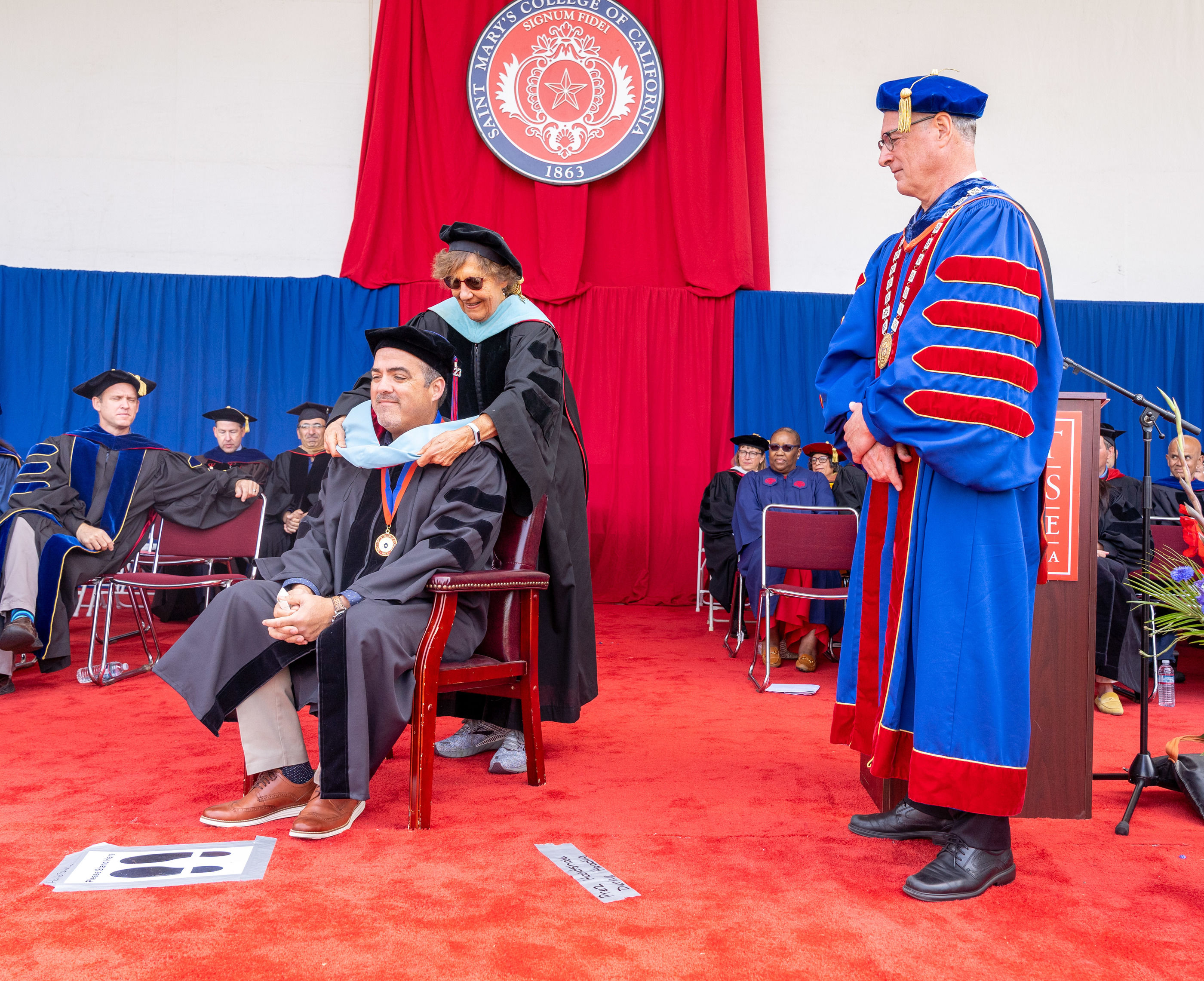 Grad student receiving hood at commencement