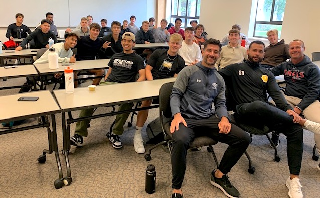 Men's soccer coaches and players in classroom Spring 2023