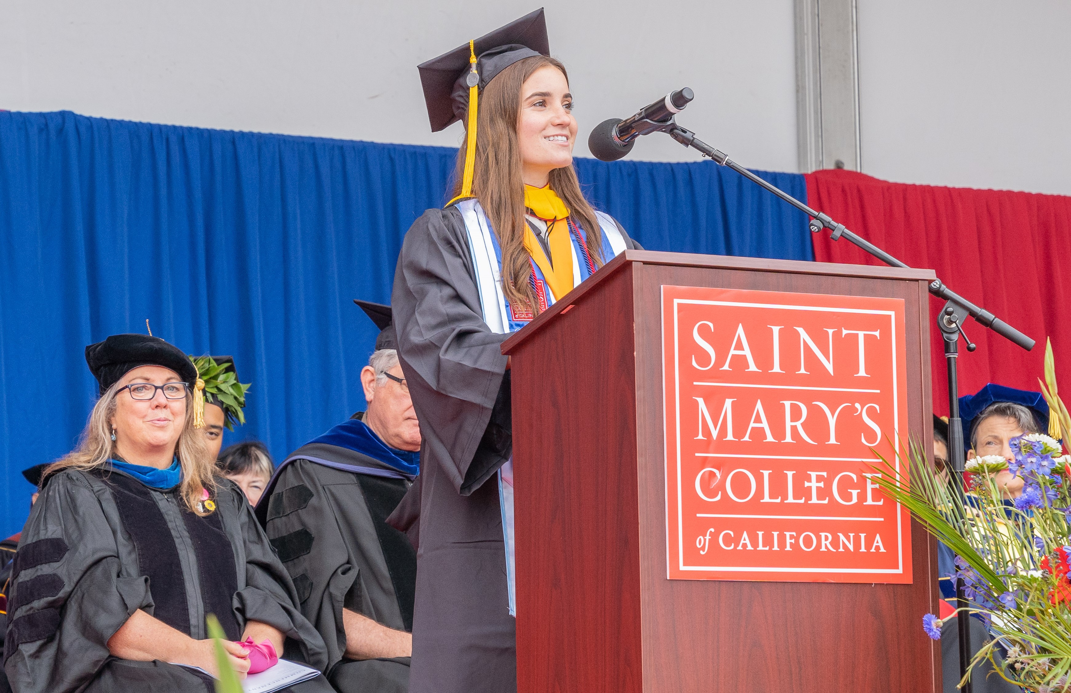 Isabella speaking at podium