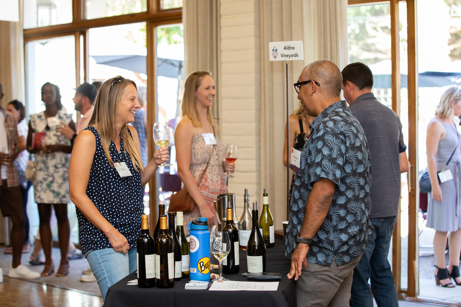 Two people share a laugh at the Summer Wine & Beer Fest