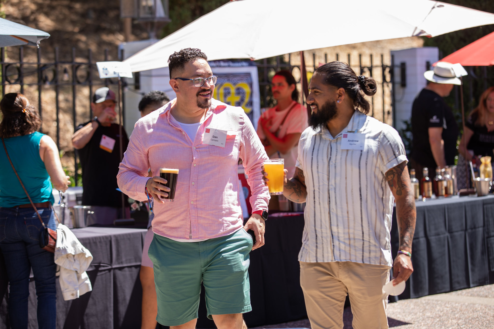 Two young men hold beers