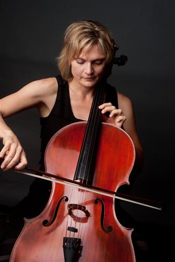 A picture of Anne Lerner-Wright playing a cello against a non-descript background. 