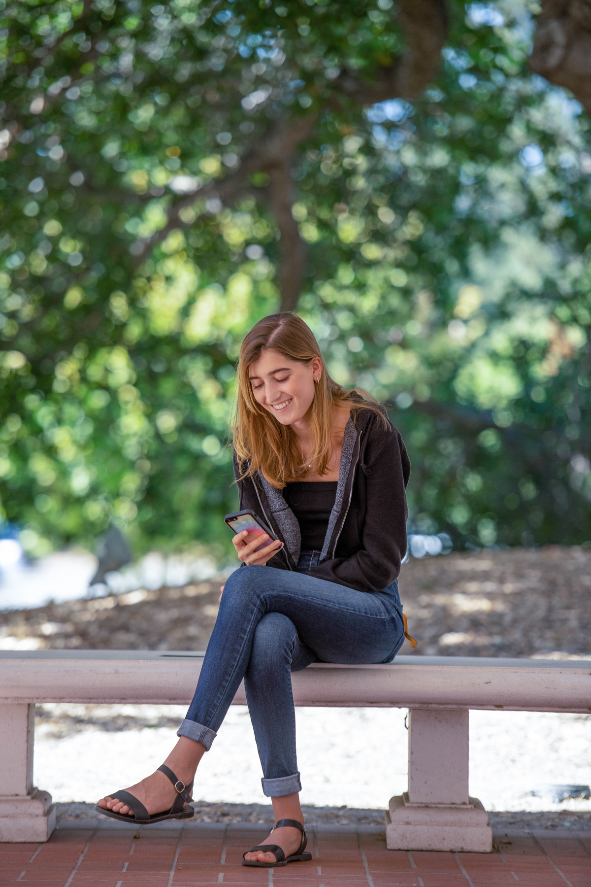 Student sitting with phone