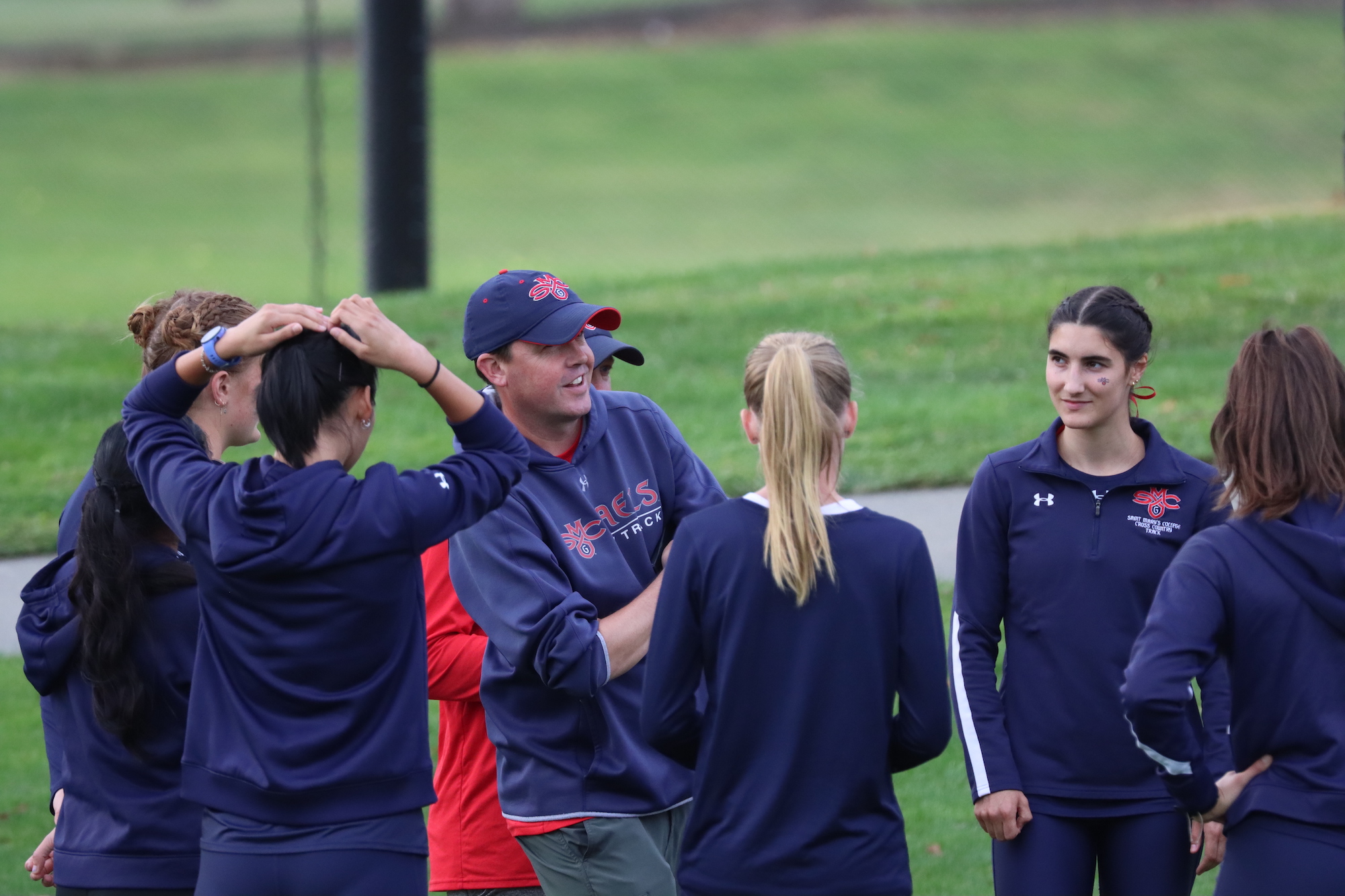 Marty Kinsey talks to student-athletes at a cross country meet