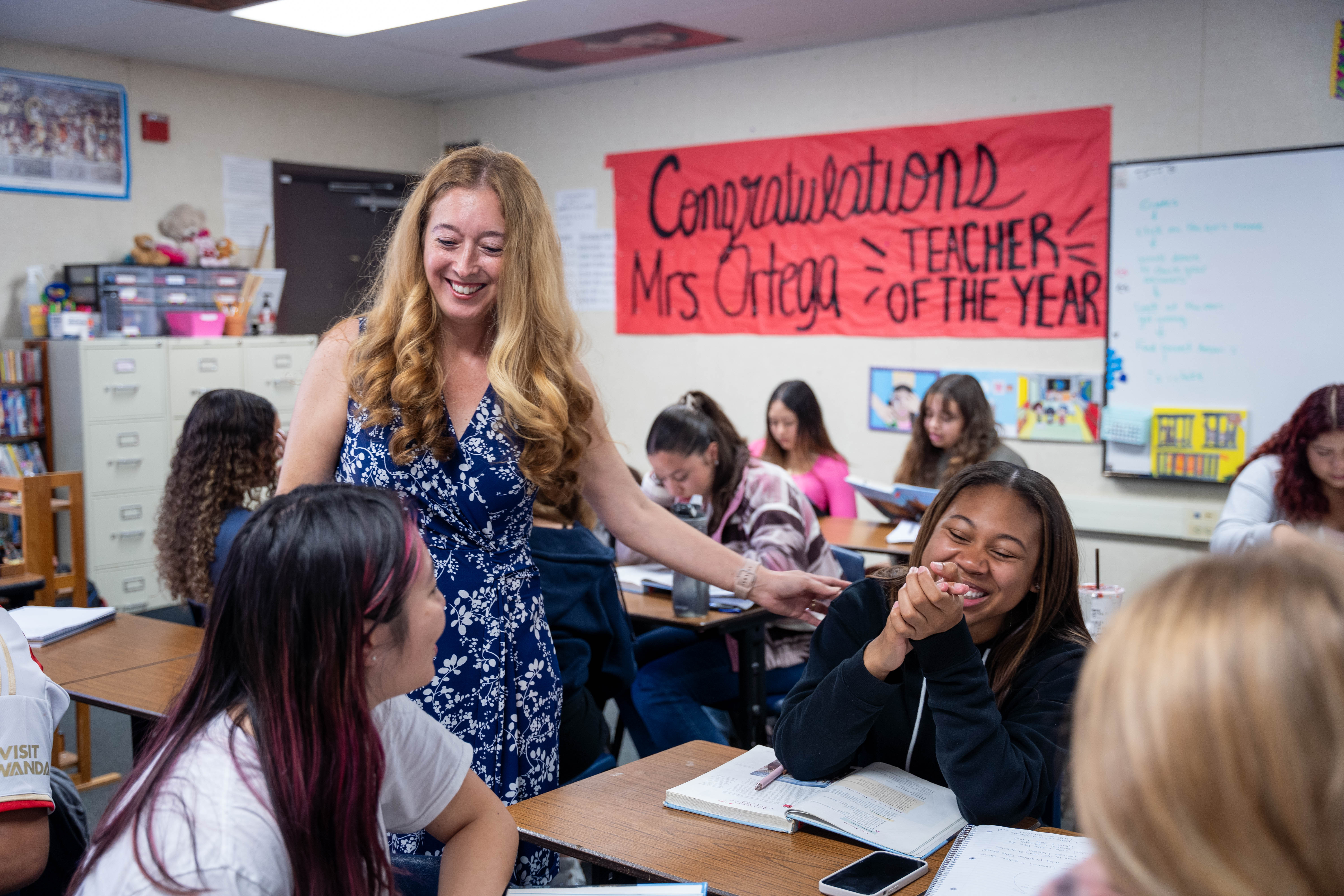 Annalouisa Gonzalez-Ortega smiles while talking with students in her classroom