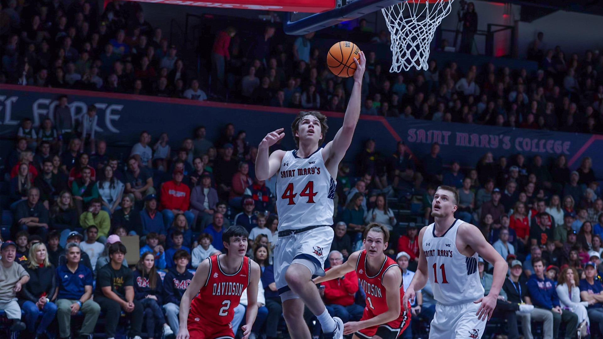 Men's basketball player Alex Ducas, No. 44, goes up for a basket against Davidson in November 2023