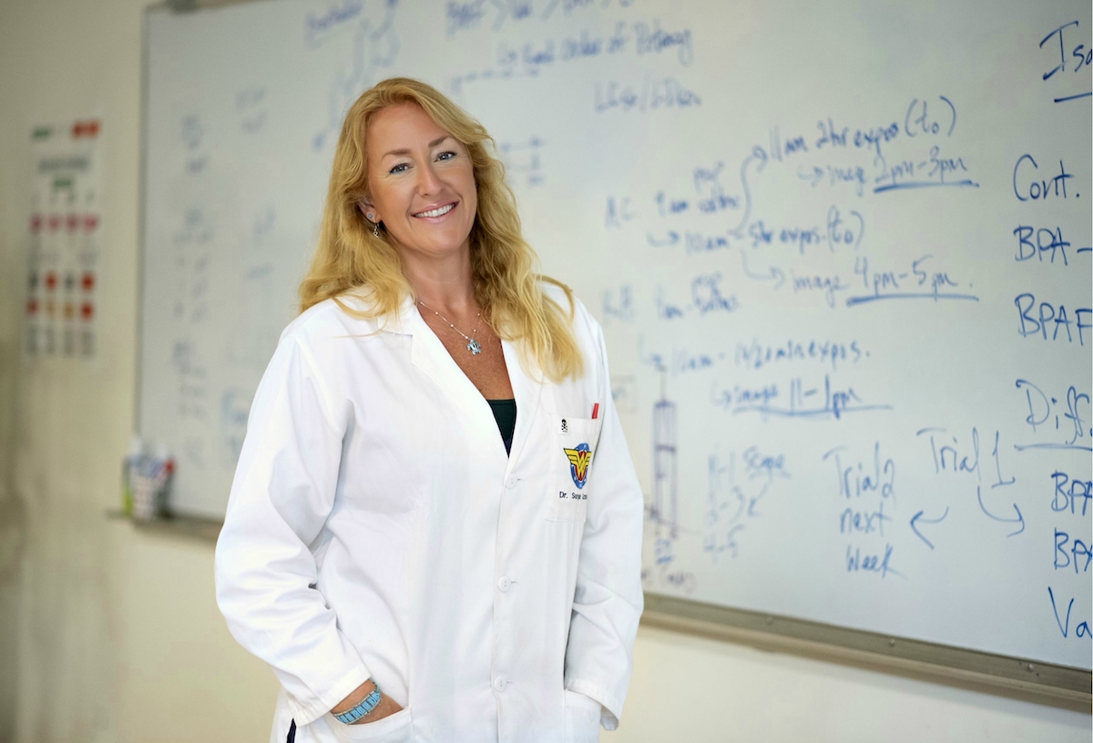 Scientist Sonya Schuh in front of whiteboard with text