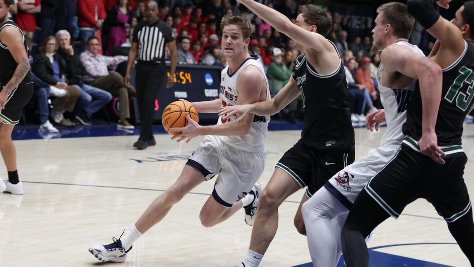 In men's basketball, Luke Barrett drives against Cleveland State in December 2023