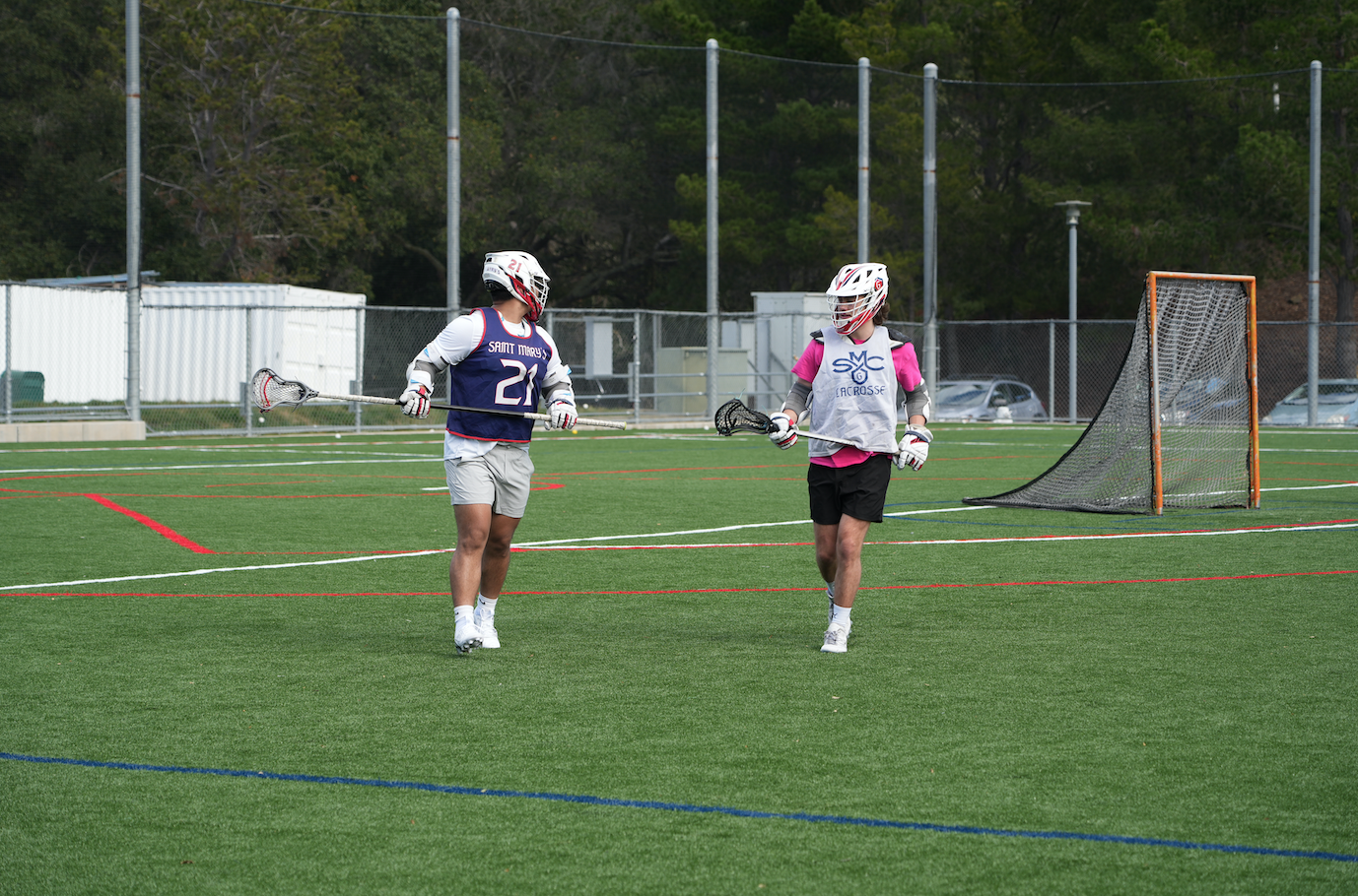 Men's Lacrosse Players on the turf field