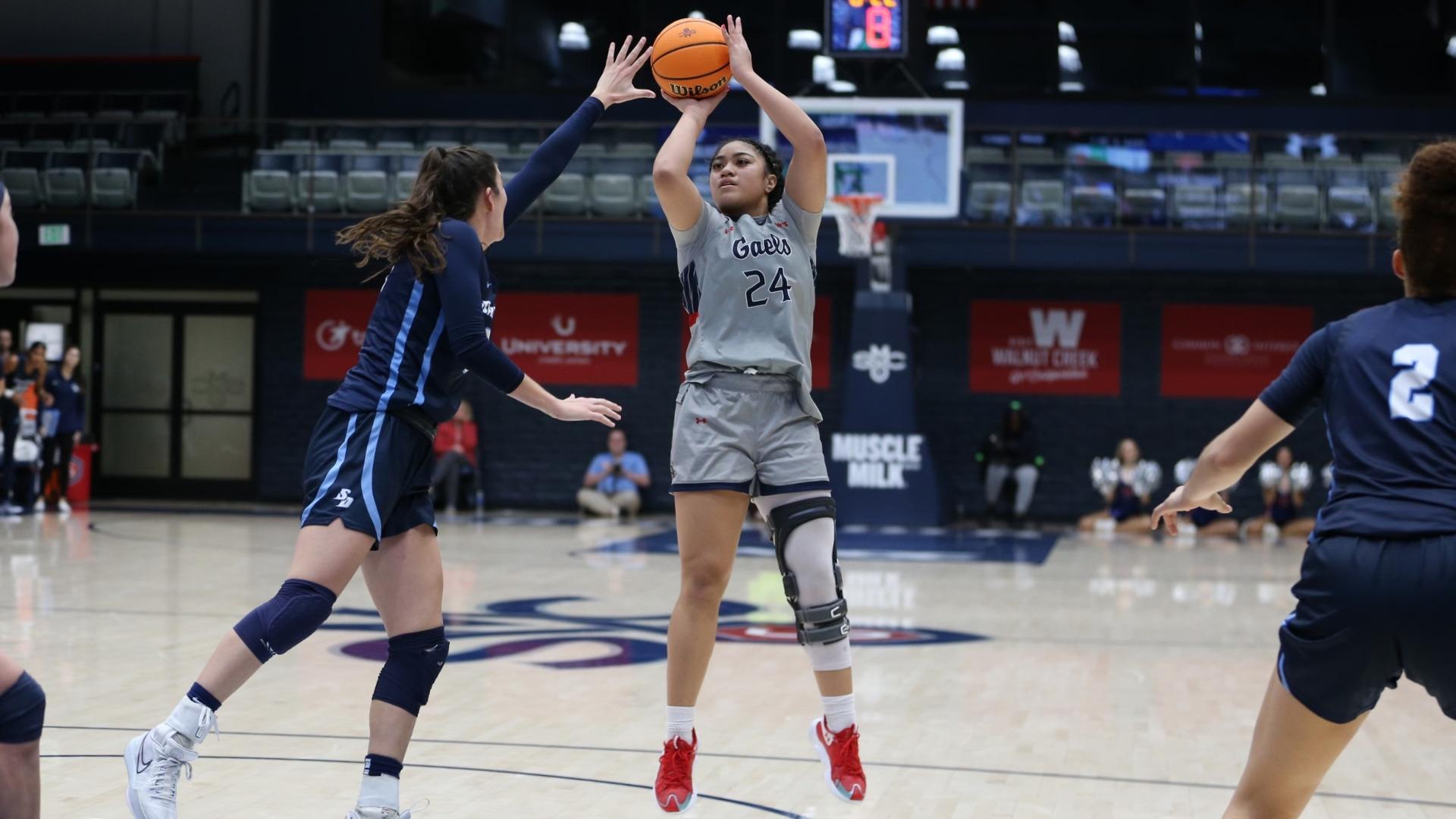 Women's basketball player Zeryhia Aokuso shoots against USD in January 2024