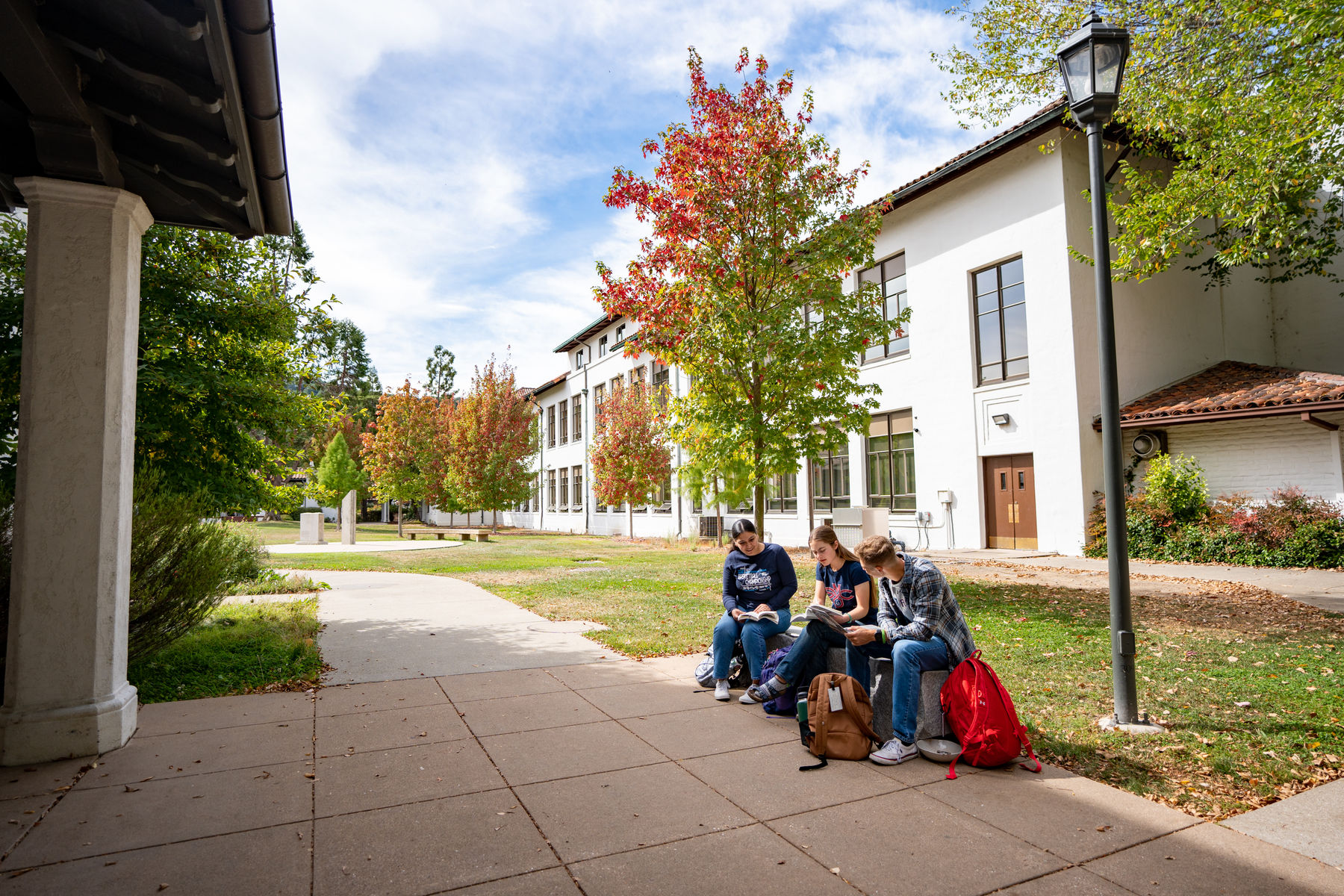 students sitting on bench at SMC
