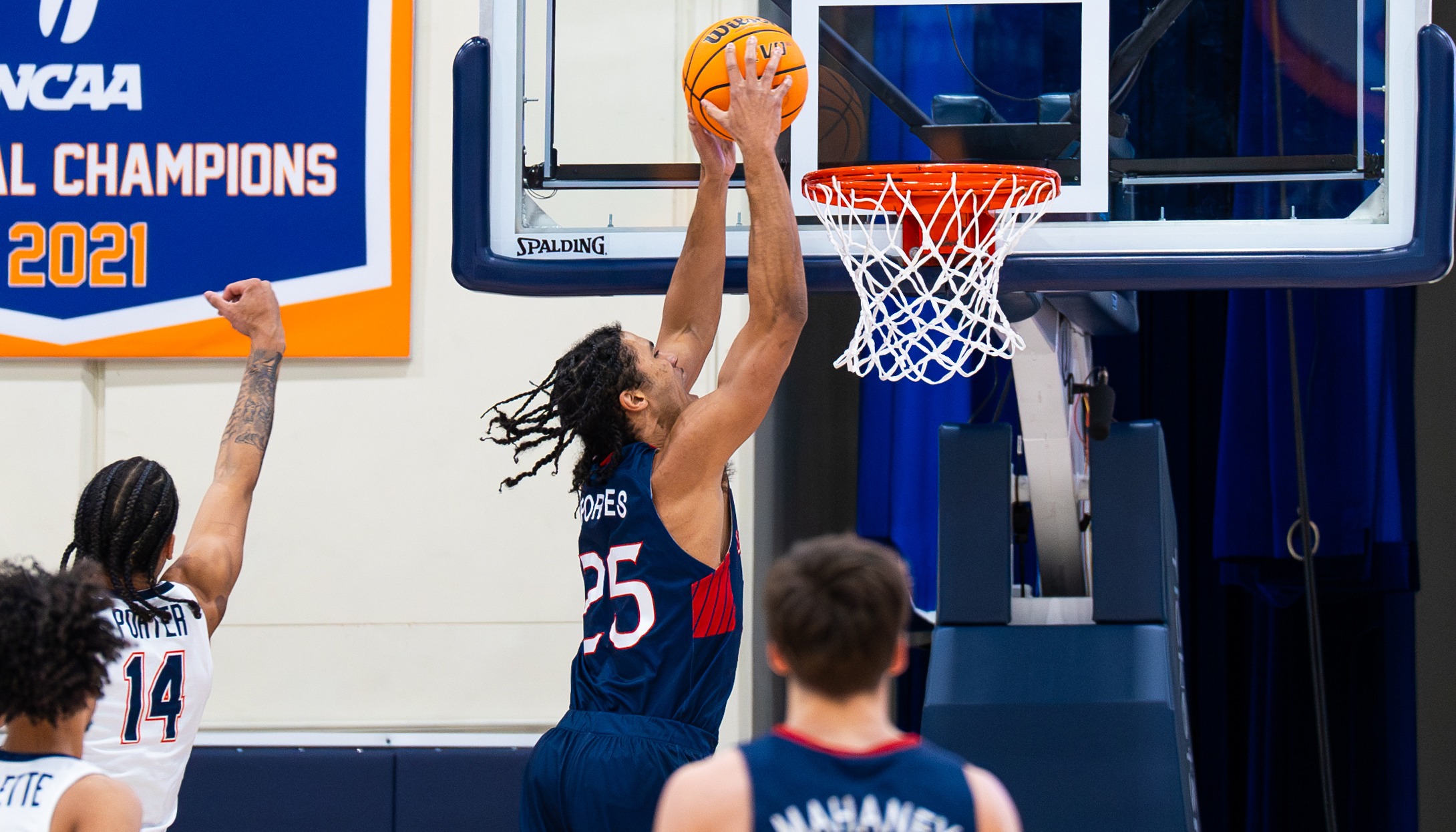 Men's Basketball Player Mason Forbes dunks basket abasing Pepperdine in February 2024