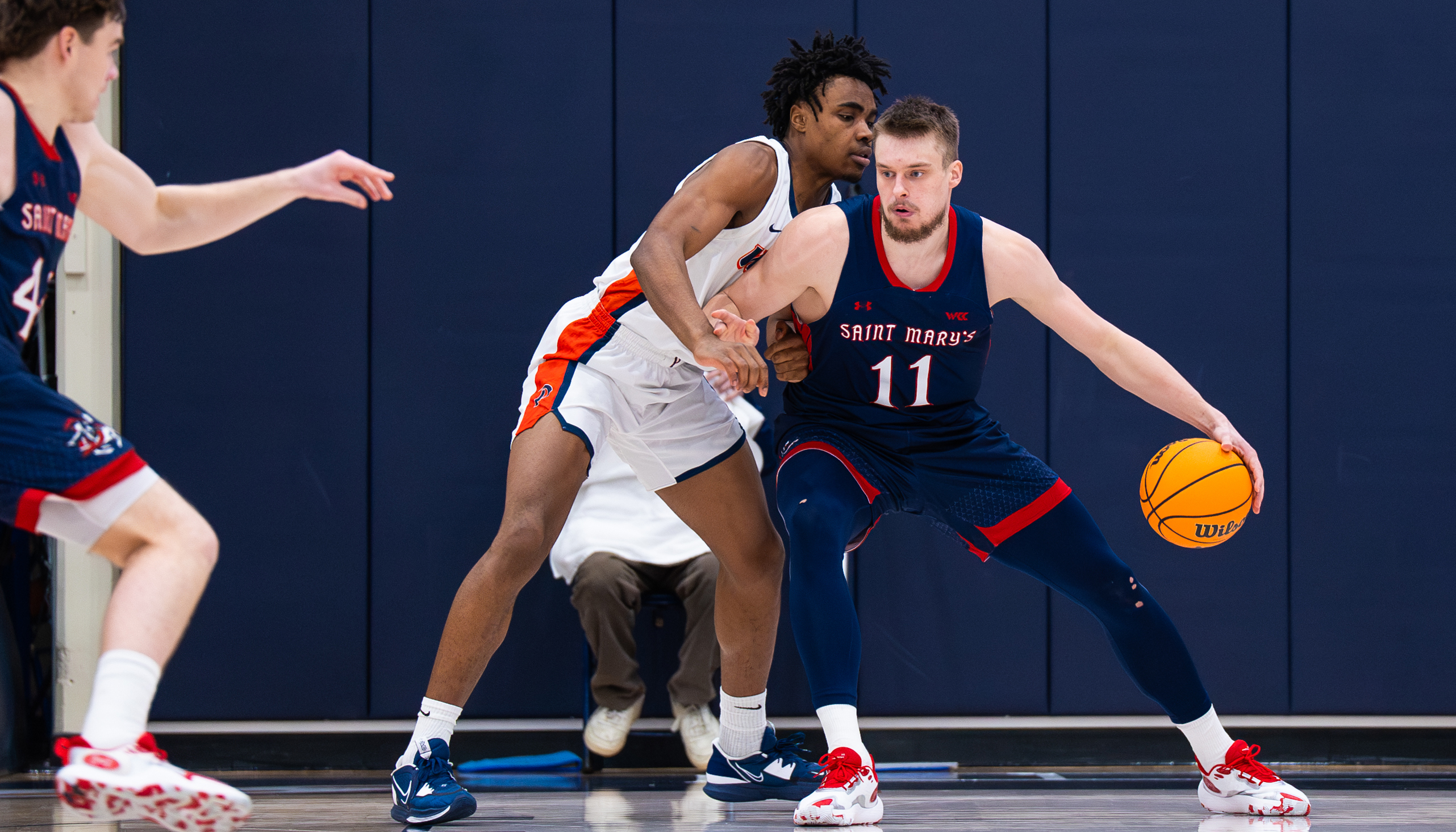 Men's basketball player Mitchell Saxen drives against Pepperdine in February 2024