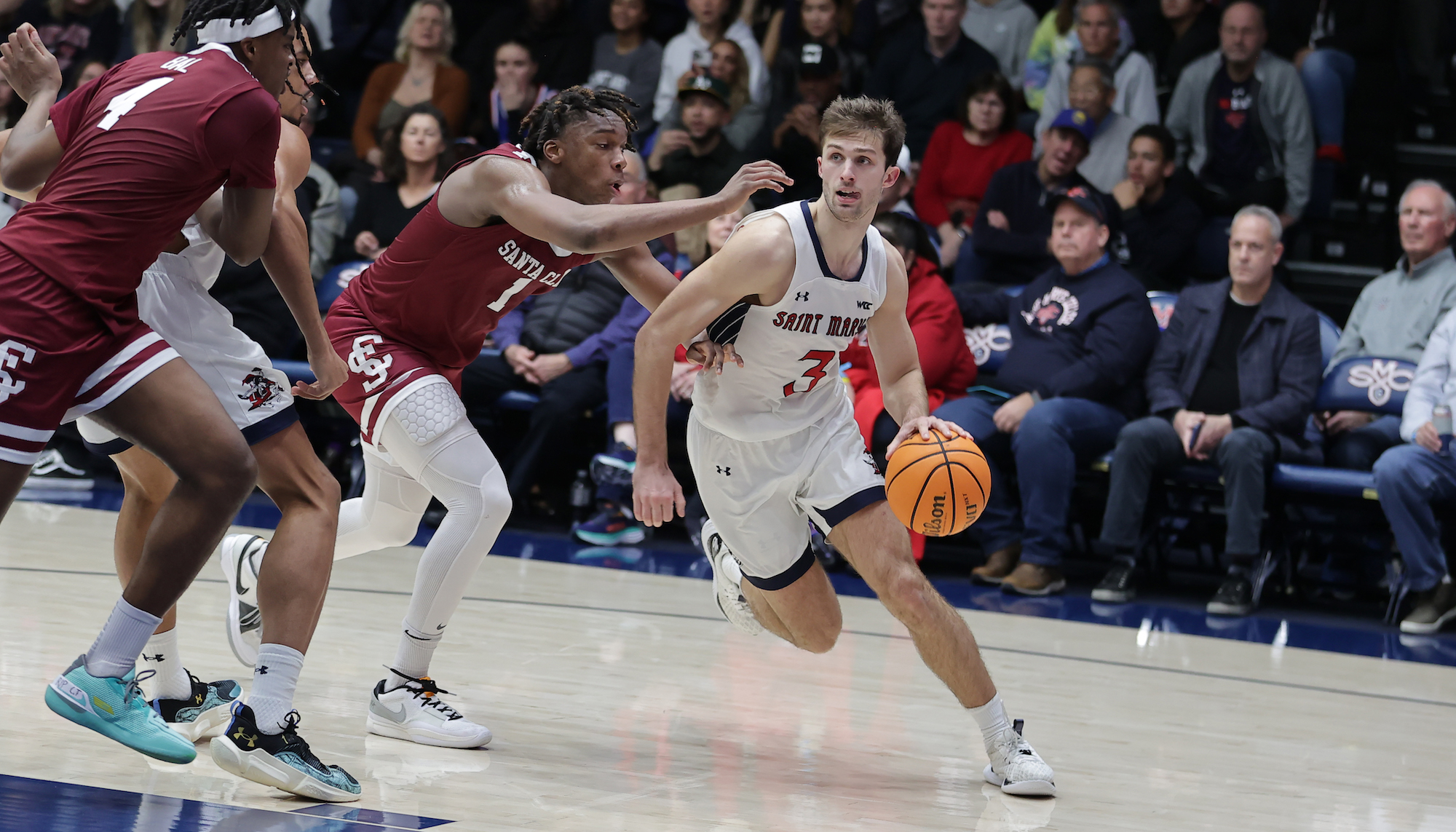 Men's basketball player Augustas Marciulionis drives against Santa Clara in January 2024