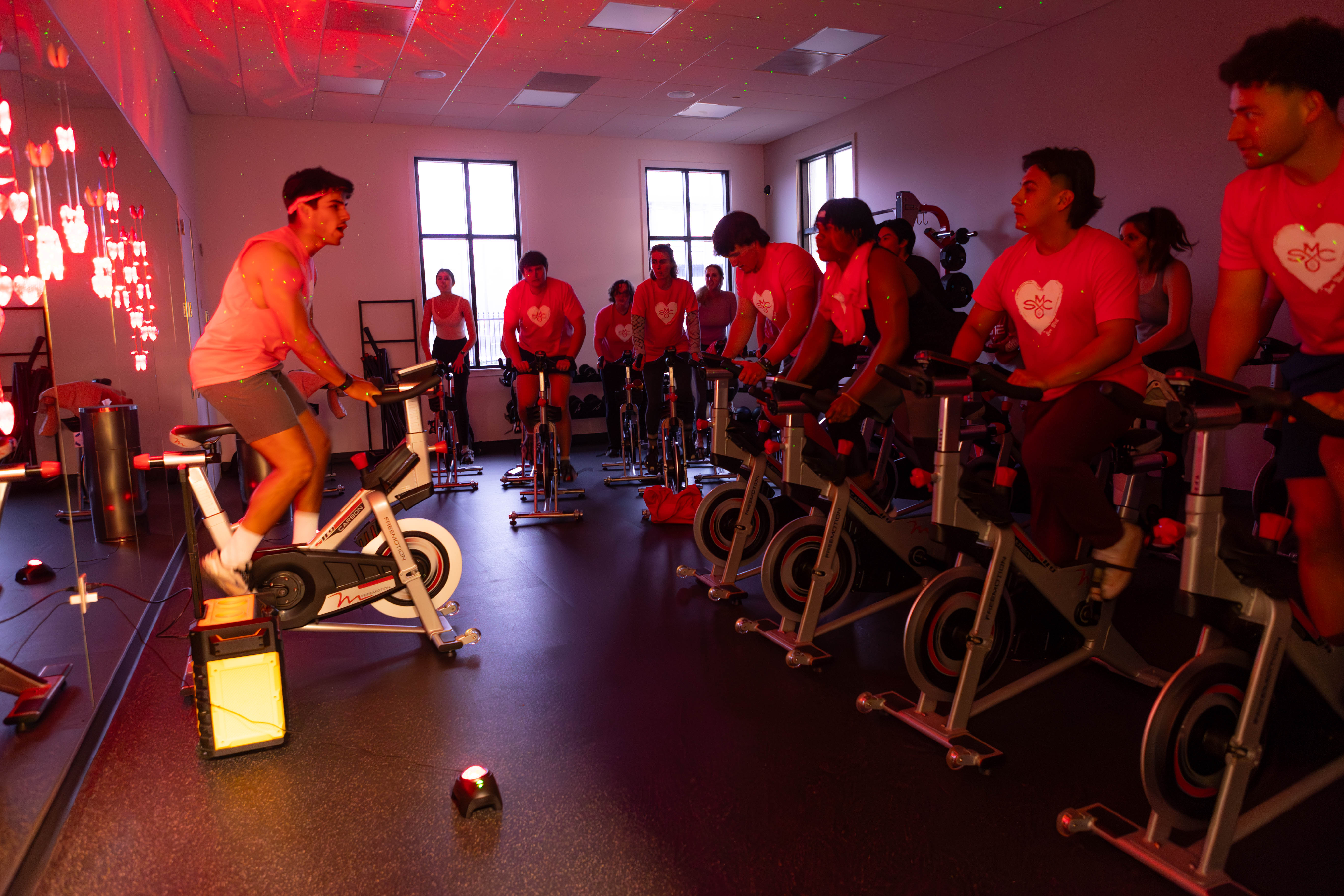 SPIN: Instructor, Jake Negrete MA’ 24 provides motivational music to encourage participants to peddle the stationary bikes at the Joseph L. Alioto Recreation Center. / Photo by Rebecca Harper