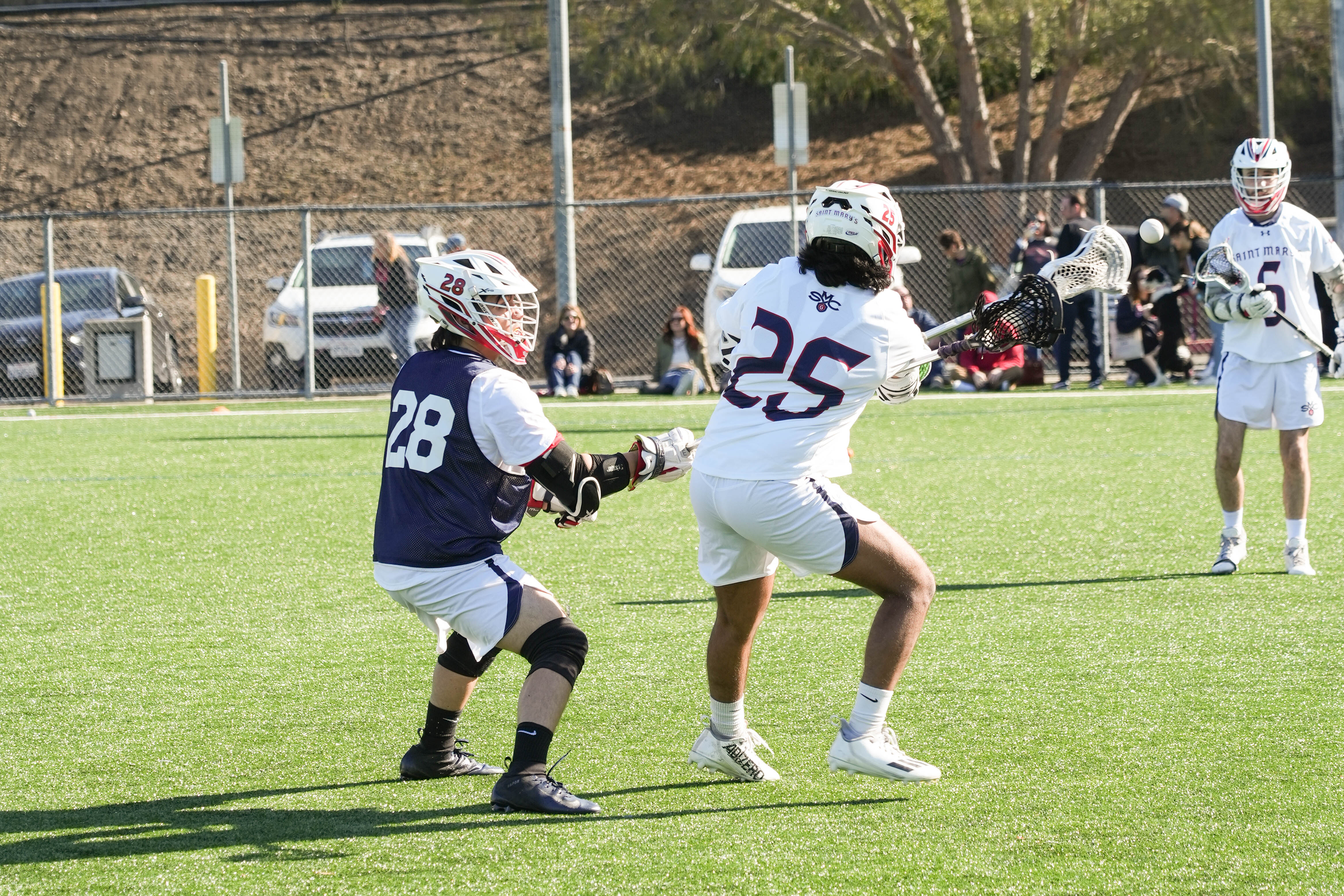 Quick Pass: #25 Ryan Senjit receives a pass from #6 Evan Salgado while blocking off the defender during the warm up against SMC Gaels and Southern Oregon.