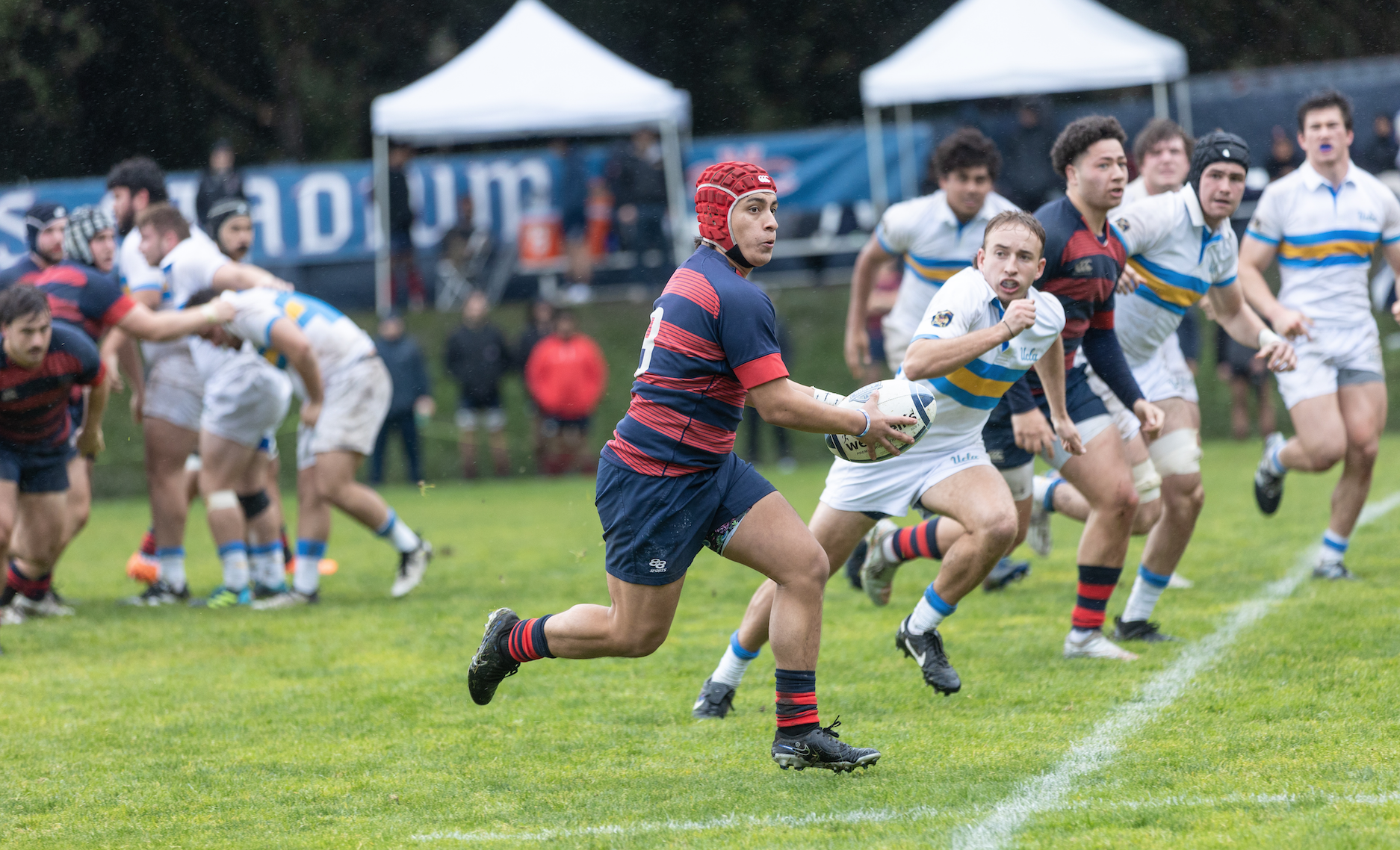 William Lhommedieu runs towards the try line during the rugby game