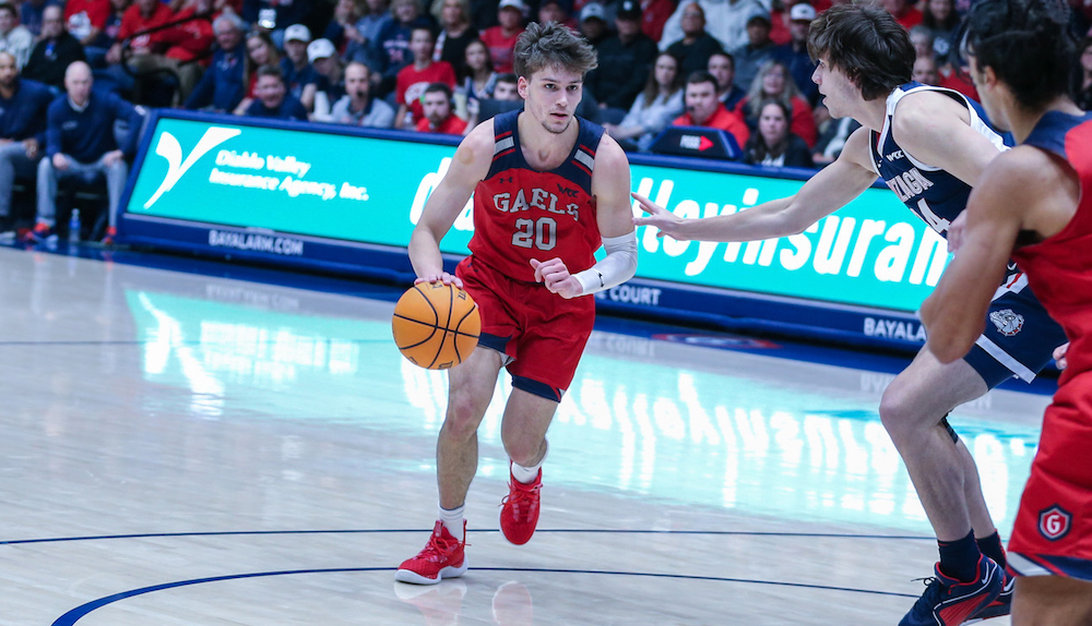 Men's basketball player Aidan Mahaney dribbles the ball against Gonzaga